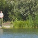 Fisherman on the Shore of a Lake or River with a Fishing Rod Catches Fish - VideoHive Item for Sale