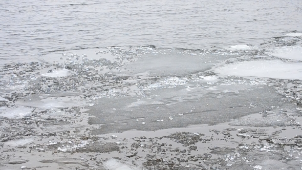 Melting Floes Of Ice Floating On Water Surface With Waves