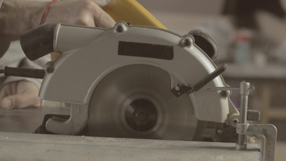 Carpenter Cut Wooden Board On Straight Line Of Metal Balk. Put Off Fasteners. alt