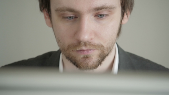Male Businessman Looking At Computer Screen In Office alt