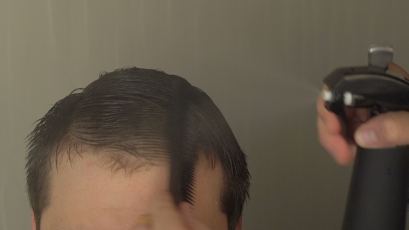 Hairdresser Styling Hair With Water And Comb 