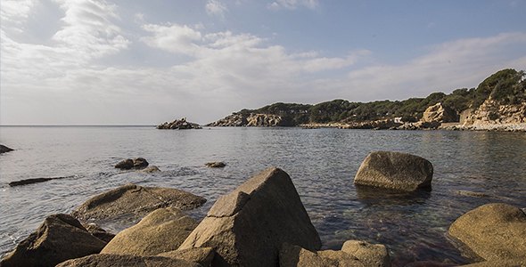 Rocks, Waves and Clouds on a Blue Sky