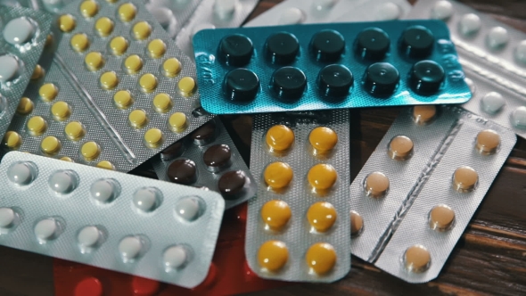Packaging Of Tablets And Pills On The Wood Table