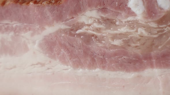 Panning on smoked  pork meat product close-up 4K 2160p 30fps UltraHD footage - Cured bacon  unhelath alt