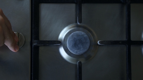 A Man Lights a Gas Stove Top alt