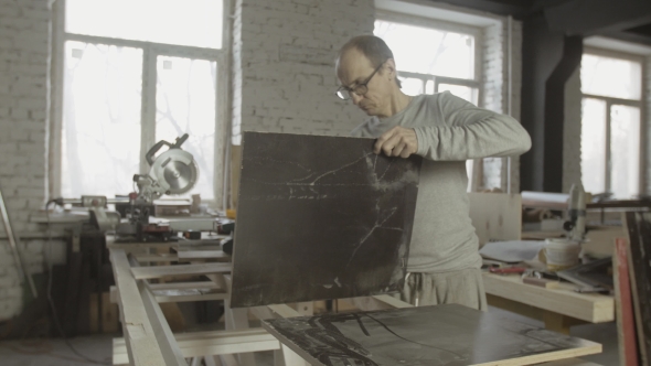 Professional Adult Carpenter Checking Result Of Work. Polished Cut Wooden Boards alt