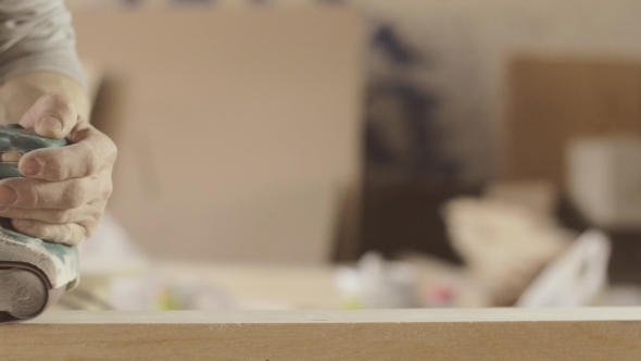 Professional Woodworker Treat Wooden Board By Belt Sander. Smooth Movements alt