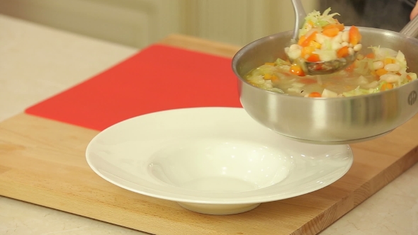 Serving Soup With Beans And Vegetables