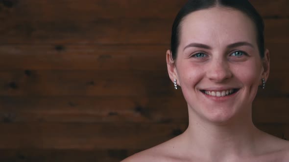 Face of a Beautiful Girl Closeup Winks and Flirts Copy Space alt