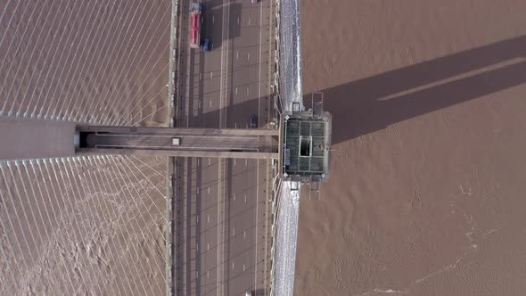Cars and Lorries Driving Across a Cable Stayed Bridge Aerial View alt