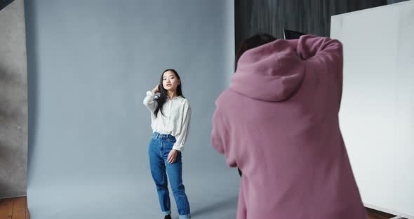 Woman Photographer with the Professional Camera Shooting Asian Korean Model alt