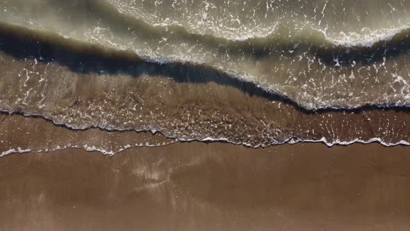 Top View of Texture Waves Sandy Beach