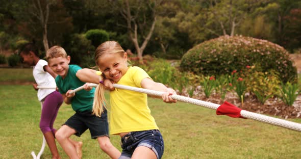 Kids playing tug of war in park, Stock Footage | VideoHive