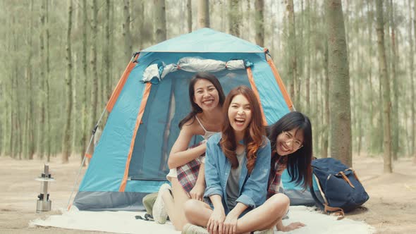 Group of young asia camper friends camping near relax enjoy moment in forest.