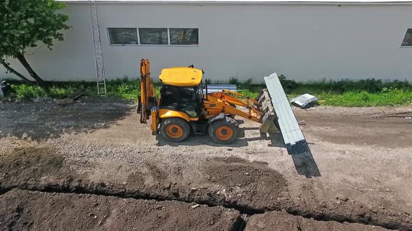 Aerial shot of construction site. Industrial excavator working on construction site alt