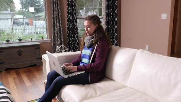 Woman working on laptop computer at home