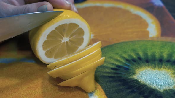 Cutting slices of fresh lemon