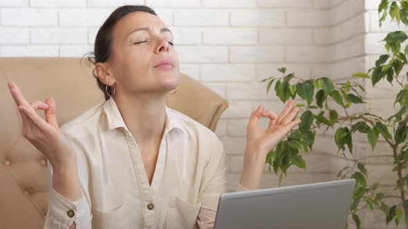 Lady concentrating on work breathing indoor. alt