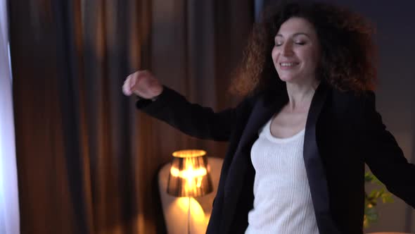 Woman in the Office Starts Dancing While Sitting at a Laptop and Goes Crazy Takes Off Her Jacket and alt