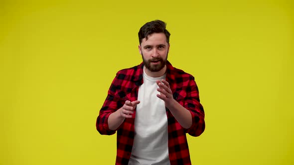 A Bearded Man Looks at the Camera Rubs His Hands Excitedly and Begins to Dance with Joy alt