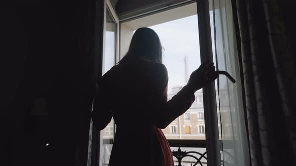 Young Happy Traveler Woman Opening Balcony Window, Enjoying Romantic Sunny Morning Paris Eiffel alt