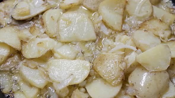 Typical Spanish Dish Made From Potatoes And Garlic, Fried In A Pan With Olive Oil, Seen From Above