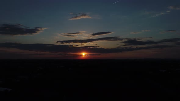 Aerial View of a Sunset Across Amish Farm Lands as Seen by a Drone alt