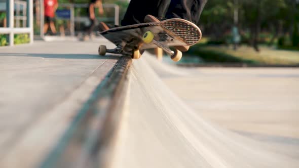 Close Up Of Skateboard Sliding On Skate Ramp