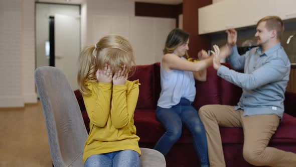 Child Girl Kid Is Suffering and Crying From Quarrels Between Parents in Family. Conflict, Crisis alt
