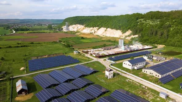 Aerial View of Electrical Power Plant with Rows of Solar Photovoltaic Panels for Producing Clean alt