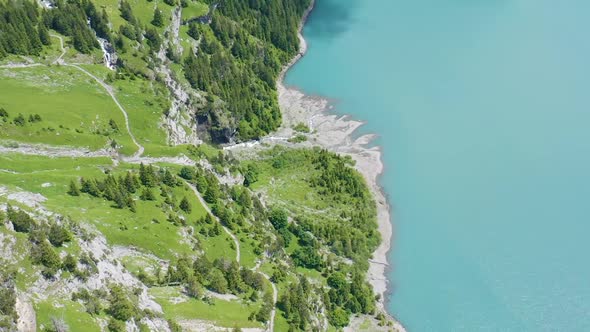 Aerial of beautiful green shoreline near a beautiful lake alt