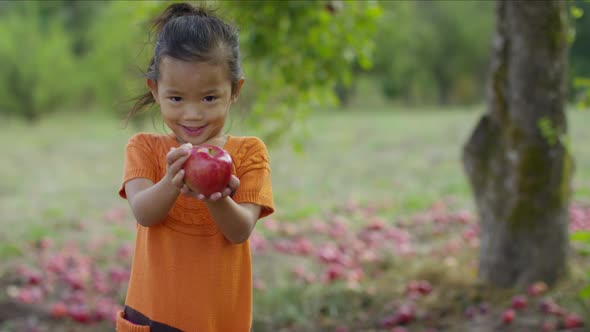 Young girl in Fall holding apple