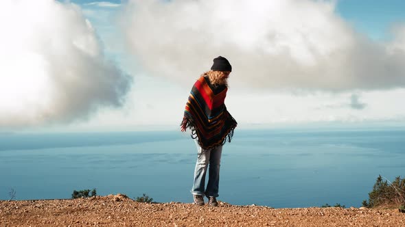 Young adult woman twirl and enjoy scenic place. Excited and overjoyed female tourist alt