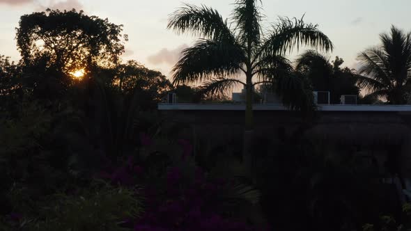 Aerial View of City and Greenery Spread Across with Buildings and Trees on a Cloudy Evening Twilight alt