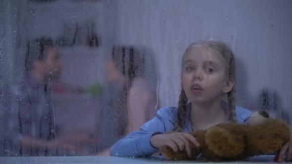 Little Girl With Teddy Bear Showing No Gesture on Rainy Day, Parents Quarrelling alt