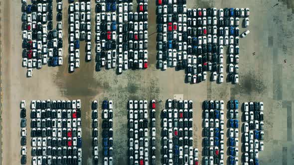 Drone Flying Over Cars Parked at a Car Dealer Parking Lot. alt
