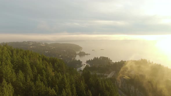 Aerial panoramic view of Sea to Sky Highway in Horseshoe Bay during a sunny winter sunset. Taken in alt