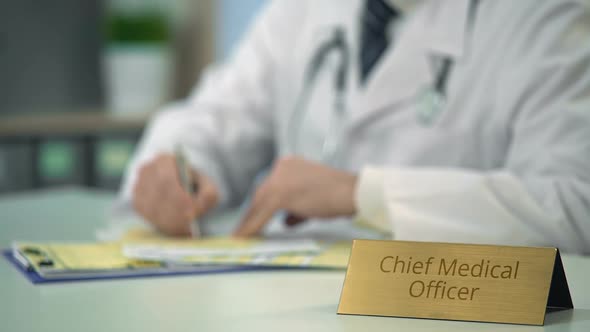 Chief Medical Officer Completing Report, Prescribing Medication in Clinic