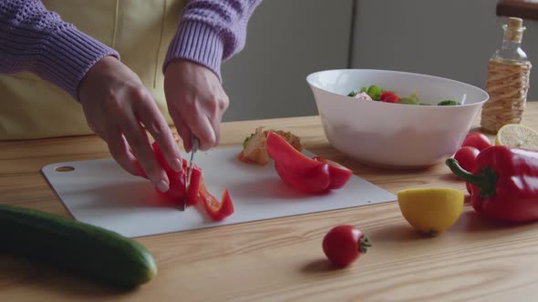 Woman Is Slicing Pepper for Salad