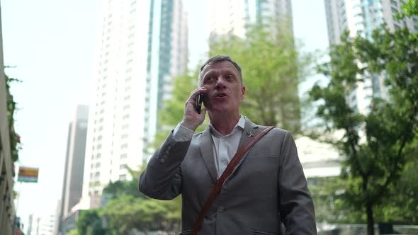 Businessman using smartphone for online business partner in city urban digital lifestyle technology. alt