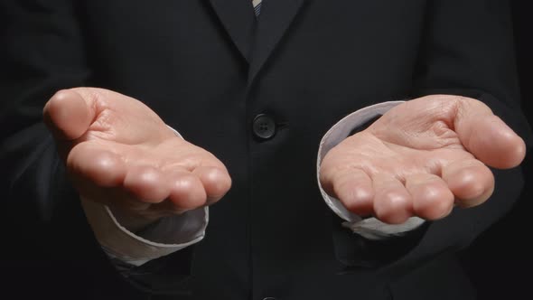 Businessman shows by hands several gestures: balance, choice