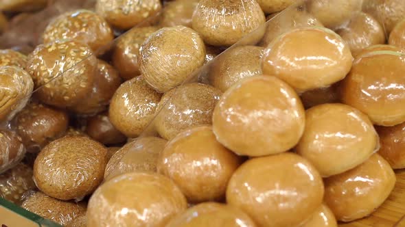 Fresh Bread in Cling Film in the Supermarket Close-up alt