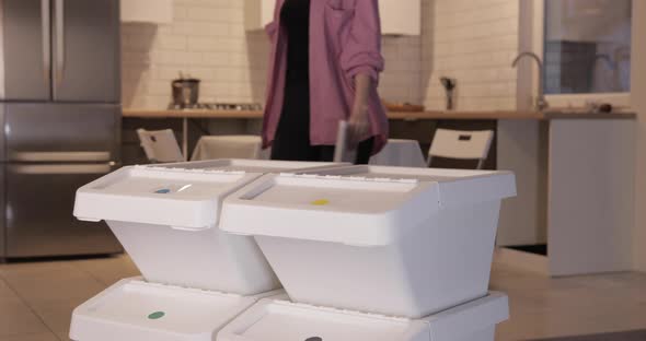 Young Woman Throwing Paper Waste Into Garbage Can for Recycling, Sorting System