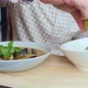 Closeup Someone Eats Tom Yam with Mussels with a Spoon From a White Plate - VideoHive Item for Sale