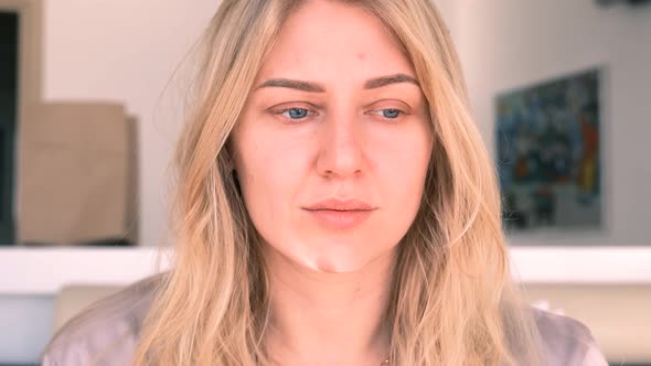 Young Beautiful Blueeyed Blonde Woman Without Makeup Looks Into the Camera