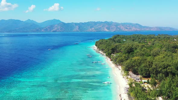 Aerial flyover of a wild tropical beach in the Dominican Republic on the Caribbean Sea. alt