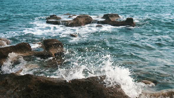 The Black Sea Shore with Boulders and Foamy Waves in Alanya in Summer