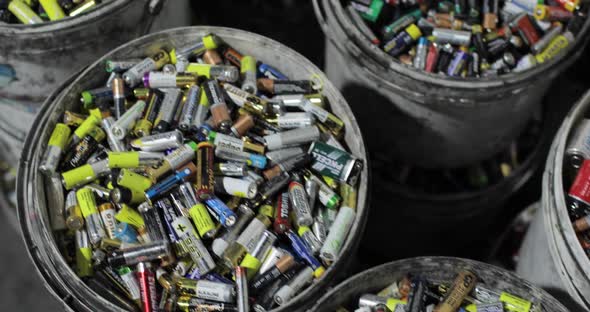 Lots of Used Batteries Sorted Into Buckets