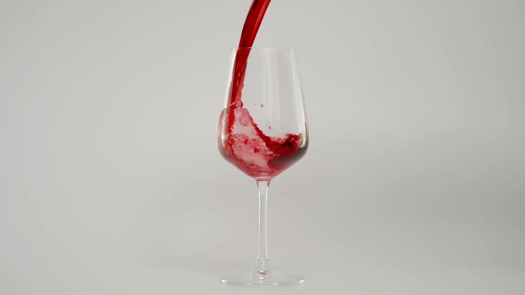 Pouring Red Wine in Glass at 1000 Fps Slow Motion Shot with White Background alt