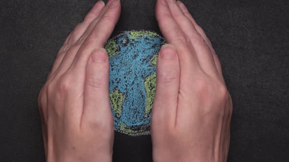 Crop Person Covering Drawn Earth